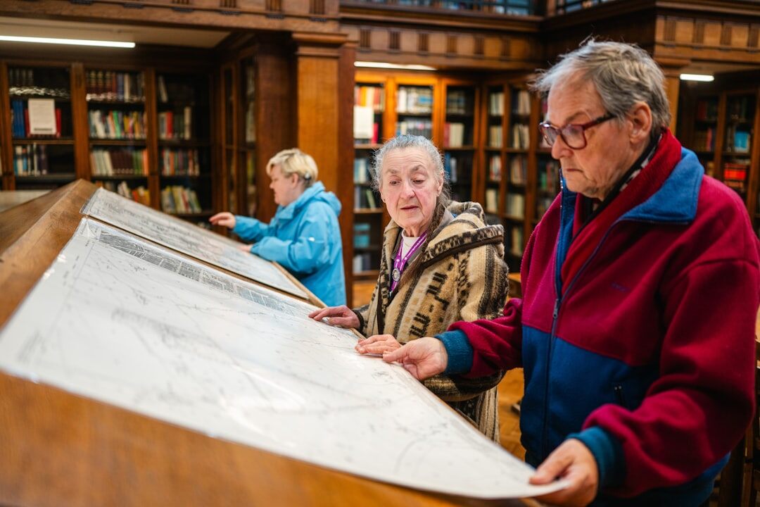 Uruguayan historian examining an old document in an archive