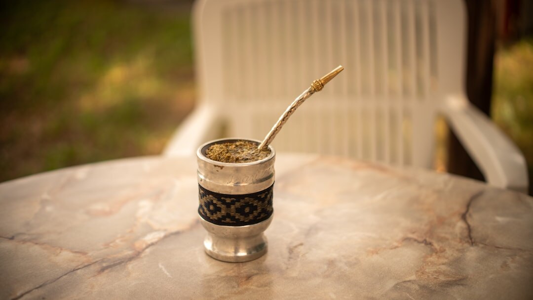 Traditional mate gourd and thermos resting on a wooden table