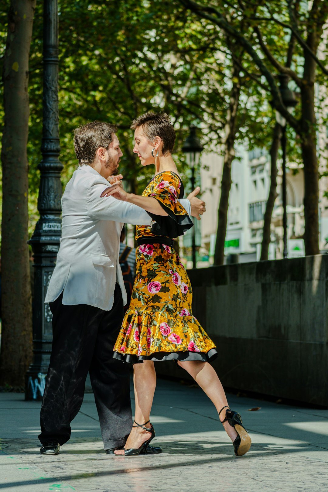 Couple dancing tango on a cobblestone plaza in Montevideo