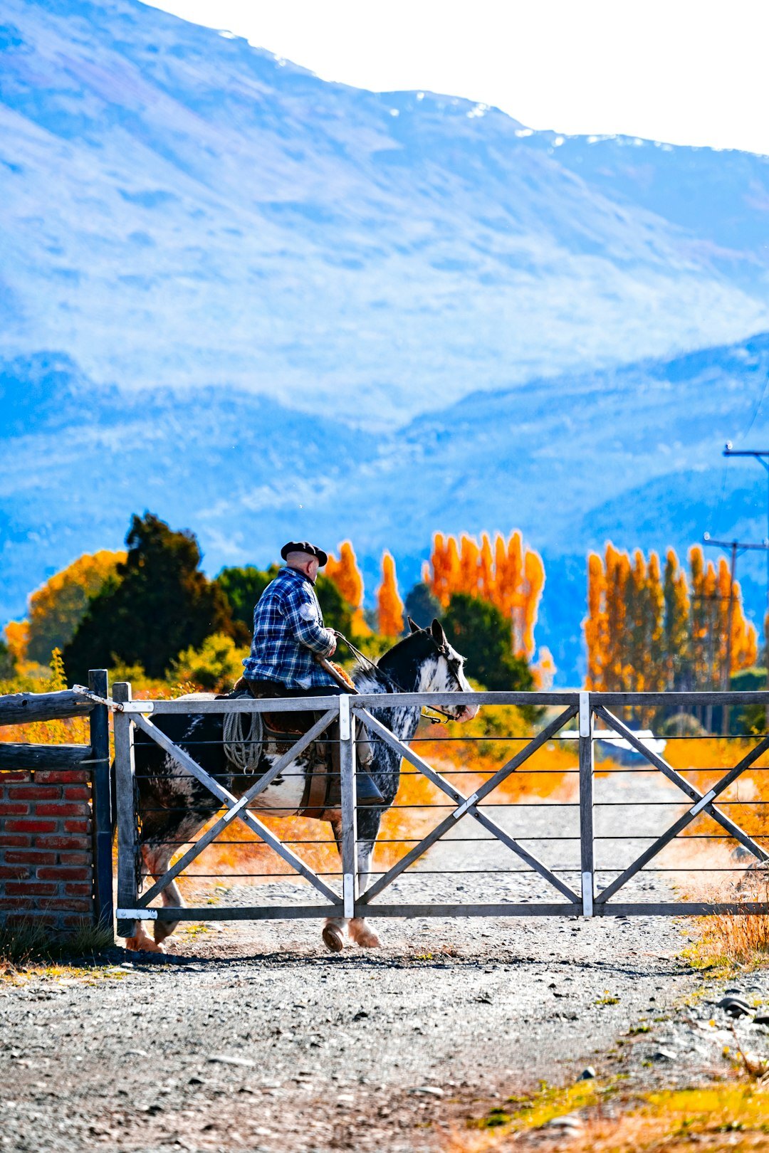 Uruguayan gaucho riding a horse across open pampas grassland